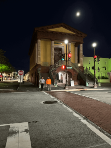 Charleston’s historic Market at night, under a full moon, with gas lamps and cobblestone streets