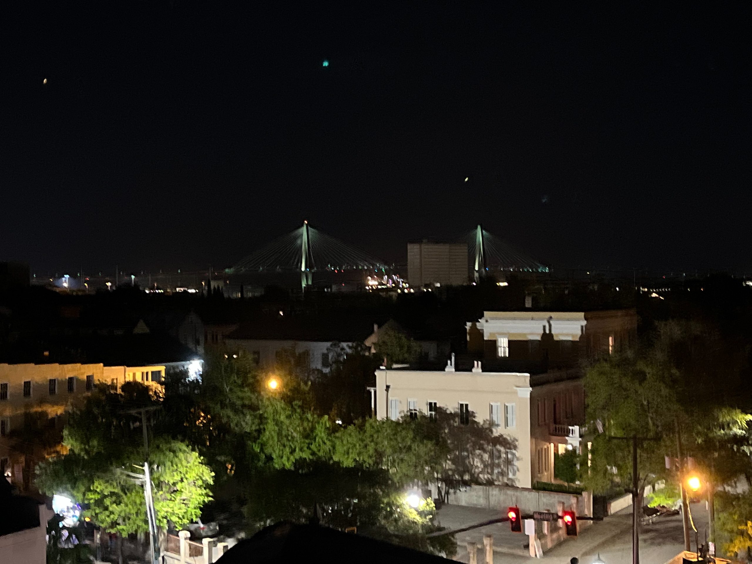 Downtown Charleston and Ravenel Bridge at Night Night view of Downtown Charleston SC and Ravenel Bridge with historic homes in foreground
